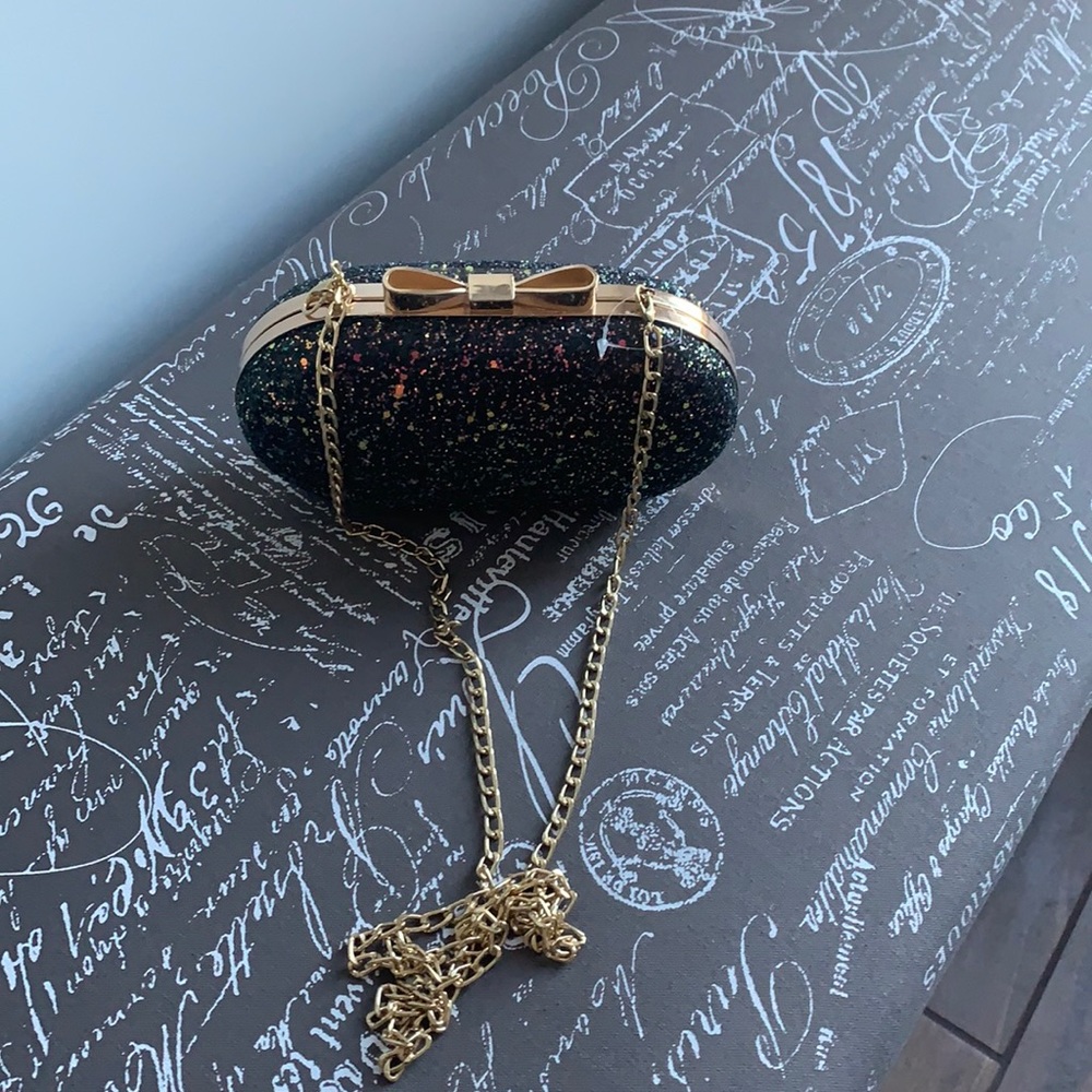 Chic and sparkly encrusted evening clutch - bow detail clasp gold colour trim.